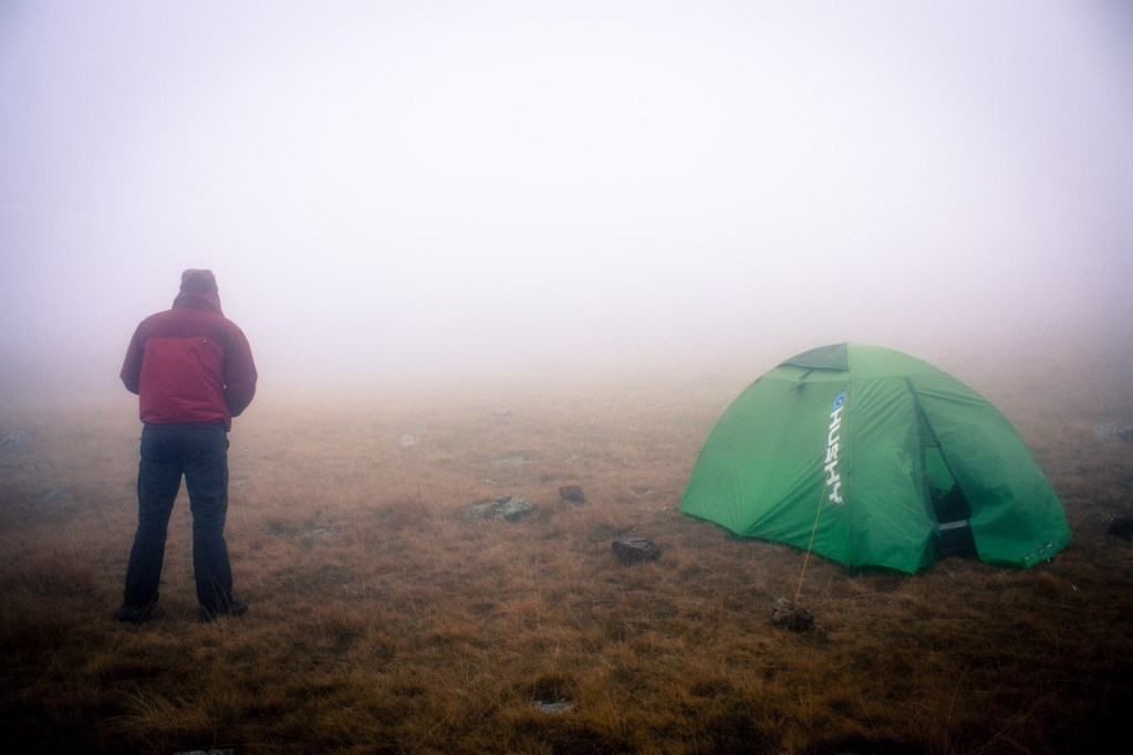 man in front of a tent